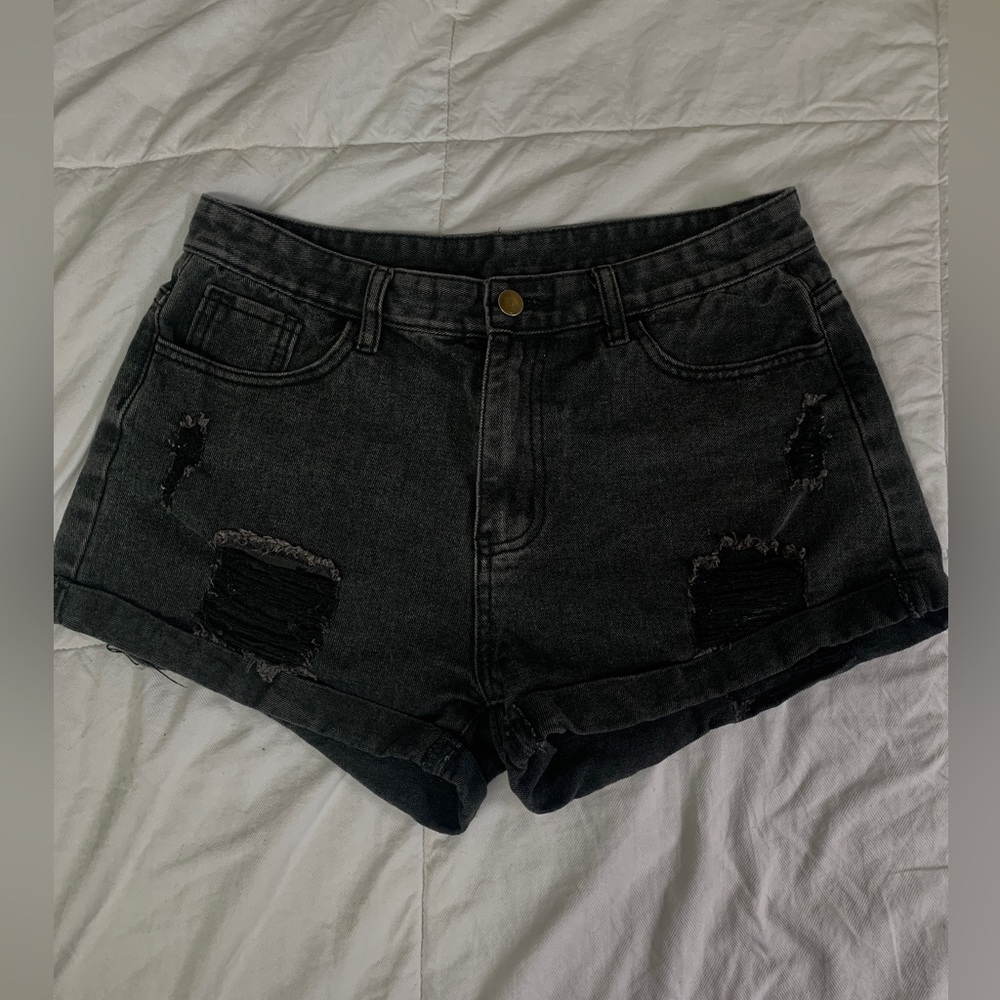 Cute women’s black ripped denim shorts